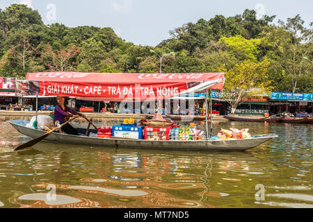 Tourist on Perfume Pagoda trip making their way to famous caves and temples in boats along Yen Vy river in North Vietnam Stock Photo