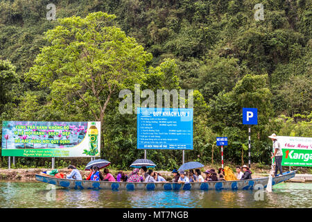 Tourist on Perfume Pagoda trip making their way to famous caves and temples in boats along Yen Vy river in North Vietnam Stock Photo