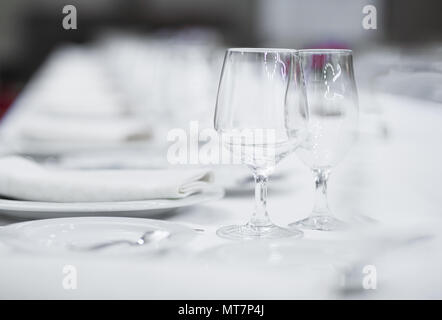 White empty plates and glasses served on a table for a celebration Stock Photo