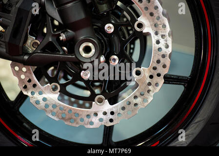 Motorcycle disk brakes and suspension on modern motorbike on orange ...