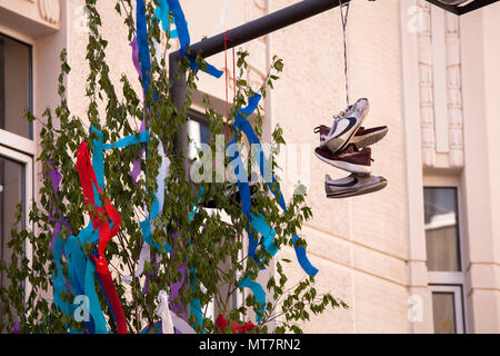 maypole and shoes on a street lamp, Cologne, Germany.  Maibaum und Schuhe an einer Strassenlaterne, Koeln, Deutschland. Stock Photo