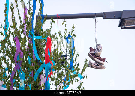 maypole and shoes on a street lamp, Cologne, Germany.  Maibaum und Schuhe an einer Strassenlaterne, Koeln, Deutschland. Stock Photo