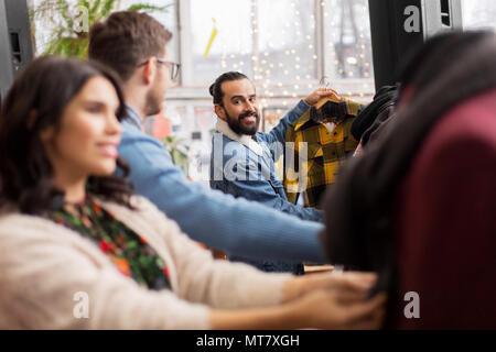 friends choosing clothes at vintage clothing store Stock Photo