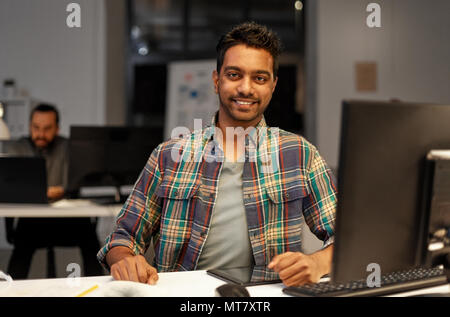 creative man with tablet pc at night office Stock Photo