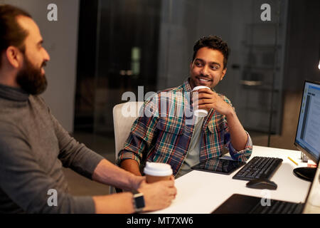 creative team drinking coffee at night office Stock Photo