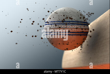 An extreme closeup slow motion action capture of a white cricket ball striking a wooden bat with dirt particles emanating on a dark isolated backgroun Stock Photo