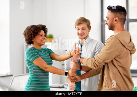 happy creative team making high five at office Stock Photo