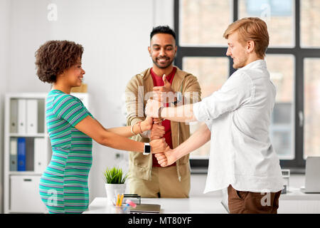 happy creative team making high five at office Stock Photo