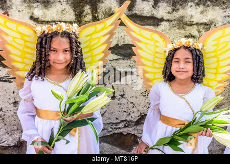 Cuidad Vieja,, Guatemala -  December 7, 2017: Girls dressed as angels in parade celebrating Our Lady of the Immaculate Conception Day. Stock Photo