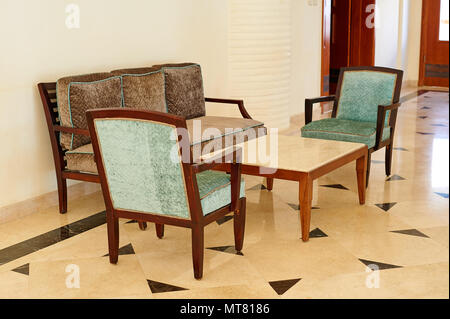 Comfortable sofa sea with two armchairs and a table with interior elements in the hotels recreation area Stock Photo
