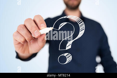 man in blue shirt with pen drawing question mark Stock Photo