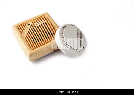 Old domestic smoke detector alarms on white background Stock Photo