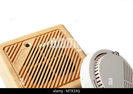 Old domestic smoke detector alarms on white background Stock Photo