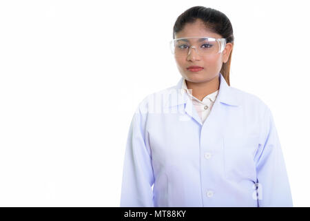 Studio shot of young fat Persian woman doctor wearing protective Stock Photo