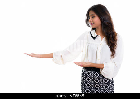 Profile view of young happy Persian businesswoman smiling while  Stock Photo