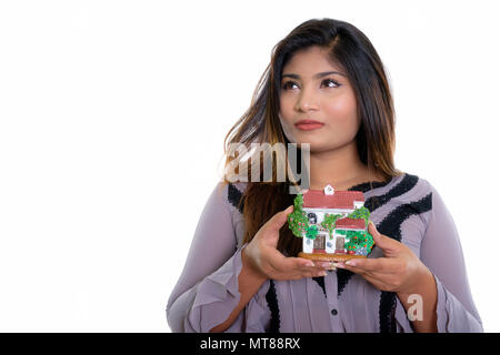 Close up of young fat Persian businesswoman thinking while holdi Stock Photo