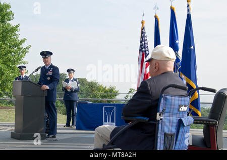 Maj. Gen. James A. Jacobson (standing at podium), Air Force District of Washington commander, delivers remarks at a Purple Heart award ceremony July 14, 2017 at the U.S. Air Force Memorial, Arlington, Va. The award was approved for World War II veteran Lt. Pedevillano (right) 72 years after he was liberated from a German prisoner of war camp by Gen. George S. Patton, Jr.’s 3rd U.S. Army. (Air Force photo by Staff Sgt. Joe Yanik) Stock Photo