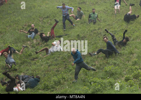 Competitors take part in the annual cheese rolling competition at Cooper's Hill in Brockworth, Gloucestershire. Stock Photo