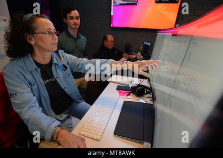 SOFWERX is a public private partnership facility supporting United States Special Operations Command technology development initiatives. The archival image documents members of the SOFWERX data science team developing software during the ThunderDrone Rodeo at a facility in Tampa, Florida, on October 31, 2017, part of a U.S. Special Operations Command drone prototyping effort. Stock Photo