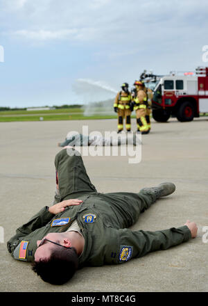 Capt. Matt McKay, a pilot trainee with the 757th Airlift Squadron here, portrays an accident victim during a Major Accident Response Exercise (MARE), May 16, 2017, while installation firefighters arrive and coordinate their initial response. The purpose of the exercise, conducted by the Wing Inspection Team and Emergency Management office, was to document response capabilities of installation personnel while honing joint response practices with local agencies including local law enforcement and the American Red Cross. (U.S. Air Force photo/Eric White) Stock Photo