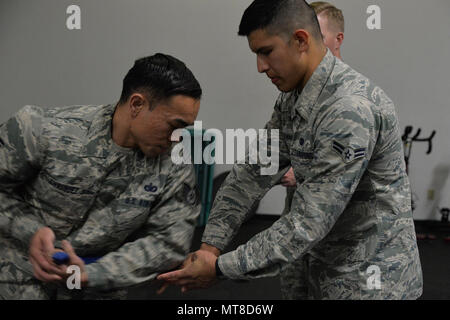 Staff Sgt. Franz Enriquez, 341st Missile Security Forces Squadron defender, and himself a Phoenix Raven, left, and Airman 1st Class Cristian Hernandez Mendoza, 341st MSFS response force leader, practice unarmed self-defense techniques before attending Phoenix Raven training May 25, 2017, at Malmstrom Air Force Base, Mont. The Phoenix Raven program ensures an acceptable level of close quarter security for aircraft transiting airfields where security is unknown or additional security is needed to counter local threats. (U.S. Air Force photo/Airman 1st Class Daniel Brosam) Stock Photo