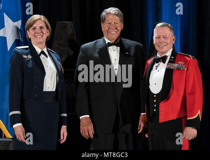 (From left to right) General Lori J. Robinson, commander of North American Aerospace Defense Command and U.S. Northern Command, Don Addy, Colorado Thirty Group chairman, and Gen. Jonathan Nance, Chief of the Defence Staff of the Canadian Armed Forces, pause for a photo during the NORAD 60th Anniversary Ball in Colorado Springs, Colo., May 11, 2018. The NORAD 60th Anniversary Ball commemorates 60 years of binational cooperation between the U.S. and Canada for the defense of North America. Established in 1958, NORAD is the world's only binational military command. (DoD photo by Staff Sgt. Emily  Stock Photo