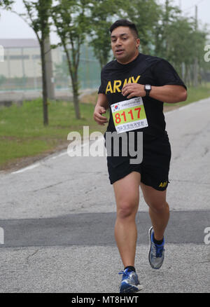 U.S. Army Chief Warrant Officer 2 William Uhila, native to Freemont, California assigned to the 65th Medical Brigade, conducts a two mile run at the Army Physical Fitness Test during the Eighth Army 2018 Best Warrior Competition, held at Camp Casey, Republic of Korea, May 14, 2018.  The Eighth Army Best warrior Competition is being held to recognize and select the most qualified junior enlisted and non-commissioned officer to represent Eighth Army at the U.S. Army Pacific Best Warrior Competition at Schofield Barracks, HI. The competition will also recognize the top performing officer, warrant Stock Photo