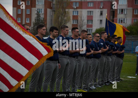 U.S. Marines with the Black Sea Rotational Force 17.1 stand for the National Anthem at the Jackie Robinson Day baseball game between the U.S. Marines and a Romanian team in Constanta, Romania April 15, 2017. The Marine and Romanian players all wore the number 42 jersey in honor of the 70th anniversary of Robinson becoming the first African American player in the Major League Baseball history. Stock Photo