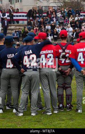 U.S. Marines with the Black Sea Rotational Force 17.1 stand with a Romanian baseball team before the Jackie Robinson Day baseball game in Constanta, Romania, April 15, 2017. The Marines and the Romanian players all wore the number 42 jersey in honor of the 70th anniversary of Robinson becoming the first African American player in the Major League Baseball history. Stock Photo