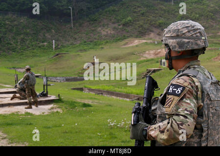 Cpl. Song, Tae Hoon, a native of Seoul, South Korea, assigned to 1st Armored Brigade Combat Team, 3rd Infantry Division as part of the rotational forces supporting 2nd Infantry Division, exits the range at the stress shoot event during the Eighth Army Best Warrior Competition, held at Camp Casey, Republic of Korea, 14 May. The Eighth Army BWC recognizes and selects the most qualified junior enlisted and non-commissioned officer to represent Eighth Army at the U.S. Army Pacific Best Warrior Competition at Schofield Barracks, HI, in June. The competition will also recognize the top performing of Stock Photo