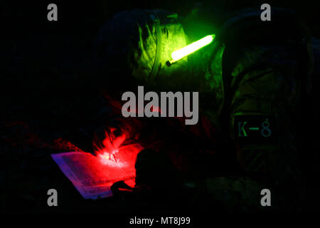 Cpl. Song, Tae Hoon, a native of Seoul, South Korea, assigned to 1st Armored Brigade Combat Team, 3rd Infantry Division as part of the rotational forces supporting 2nd Infantry Division, plots points on a map at the night land navigation event during the Eighth Army Best Warrior Competition, held at Camp Casey, Republic of Korea, 14 May. The Eighth Army BWC recognizes and selects the most qualified junior enlisted and non-commissioned officer to represent Eighth Army at the U.S. Army Pacific Best Warrior Competition at Schofield Barracks, HI, in June. The competition will also recognize the to Stock Photo