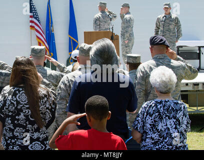 Attendees honor the U.S. flag as the national anthem is sung at the Joint Base San Antonio Airman Leadership School naming ceremony at JBSA-Lackland, Texas, May 11, 2018. The school was named in honor of Staff Sgt. Cierra Rogers, an alumnus, who died May 20, 2016, from injuries sustained after saving a family from a burning building April 29, 2016. (U.S. Air Force photo by Tech. Sgt. R.J. Biermann) Stock Photo