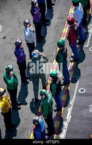180514-N-JU894-0008 ATLANTIC OCEAN (May 14, 2018) Sideboys render honors for Chief of Naval Operations Adm. John Richardson on the flight deck of the aircraft carrier USS George H.W. Bush (CVN 77). The ship is underway in the Atlantic Ocean conducting carrier air wing exercises with the French navy to strengthen partnerships and deepen interoperability between the two nations' naval forces. (U.S. Navy photo by Mass Communication Specialist 3rd Class Brooke Macchietto) Stock Photo