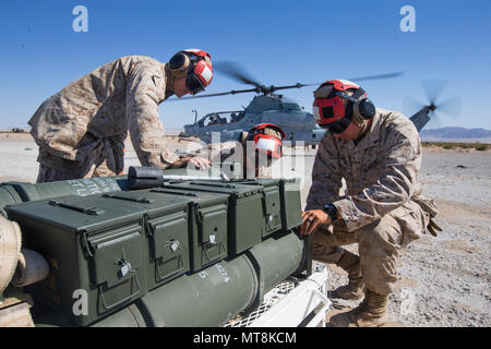 AH-1Z Viper is a twin-engine attack helicopter manufactured by Bell Helicopter for the United States Marine Corps. Ordnance technicians with Marine Light Attack Helicopter Squadron 367 prepared munitions resupply during Integrated Training Exercise 3-18 at Marine Corps Air Ground Combat Center Twentynine Palms, California, on May 14, 2018. This archival image documents aircraft weapons loading procedures. Stock Photo