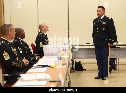 U.S. Army Chief Warrant Officer 2 William Uhila, native to Freemont, California assigned to the 65th Medical Brigade, answers a question at the Warrant Officer Board during the Eighth Army 2018 Best Warrior Competition, held at Camp Casey, Republic of Korea, May 16, 2018.  The Eighth Army Best warrior Competition is being held to recognize and select the most qualified junior enlisted and non-commissioned officer to represent Eighth Army at the U.S. Army Pacific Best Warrior Competition at Schofield Barracks, HI. The competition will also recognize the top performing officer, warrant officer a Stock Photo
