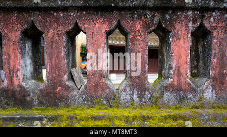 Masonry wall with decorative gaps and moss Stock Photo