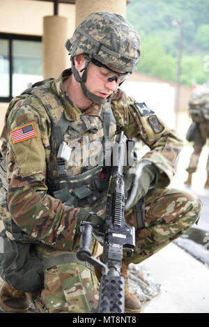 2nd Lt. Brian Trabun, a native of Seattle, WA, assigned to 35th Air Defense Artillery Brigade, assembles an M240 machine gun at the day stakes challenge during the Eighth Army 2018 Best Warrior Competition, held at Camp Casey, Republic of Korea, May 17. The Eighth Army BWC is being held to recognize and select the most qualified junior enlisted and non-commissioned officer to represent Eighth Army at the U.S. Army Pacific Best Warrior Competition at Schofield Barracks, HI, in June. The competition will also recognize the top performing officer, warrant officer and Korean Augmentation to the U. Stock Photo