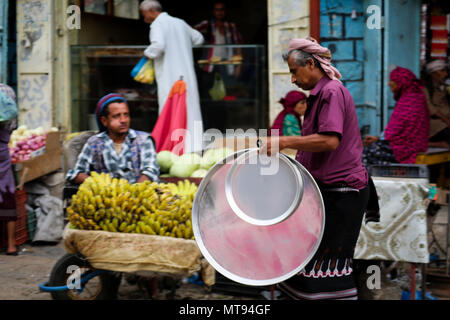 May 16, 2018 - The historic Bab Al- Musa market in the Yemeni city of Taiz becomes very busy with residents shopping during Ramadan. The construction of the market of Bab Musa and the walls of the old city dates back to the Ottoman era in Yemen, with the market developing with the construction of the Bab Al-Musa Gate in the eighth century. Taiz remained a walled city until 1948 when Imam Ahmed allowed for expansion beyond its fortified wall. Taiz, which is located in south-western Yemen, is the third largest city in Yemen, and was its cultural capital until before becoming deeply entangled in Stock Photo