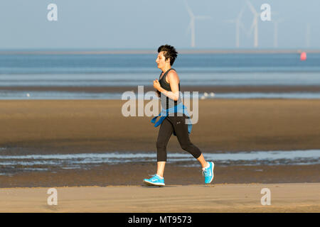 Crosby, Liverpool.  29th May, 2018. UK Weather:  Bright summer day on the north-west coast as local residents and holidaymakers take early morning exercise on the coastal path and Merseyside beach. The beach is festooned with Spring Bank Holiday litter with overflowing bins and garbage blowing in the breeze. The Sefton council containers clearly inadequate for the amount of plastic waste. Credit: MediaWorldImages/AlamyyLiveNews. Stock Photo