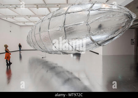 London, UK. 29th May, 2018. Willing to be Vulnerable, 2015-16, A giant silver zeppelin (approximately 17 metres wide) installed on a silver mirrored floor - Lee Bul: Crashing, a new exhibition at Hayward Gallery featuring work by one of Asia’s most acclaimed contemporary artists. This ambitious exhibition explores the full range of her pioneering and thought-provoking work from the past three decades. Credit: Guy Bell/Alamy Live News Stock Photo