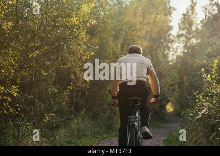 Portrait of man riding cycle in countryside Stock Photo