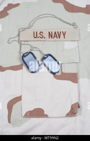 KIEV, UKRAINE - May 9, 2015. US NAVY branch tape with dog tags on desert camouflage uniform background Stock Photo