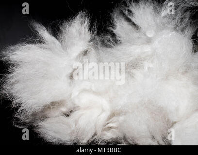 white furry coat on black background Stock Photo