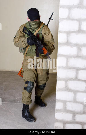 guerillas sniper with sniper rifle inside the building Stock Photo