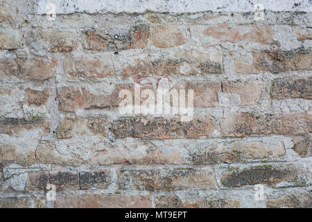 Old wall made of big stones and broken bricks. Vintage rough blocks surface background Stock Photo