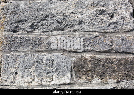 Old wall made of big stones and broken bricks. Vintage rough blocks surface background Stock Photo