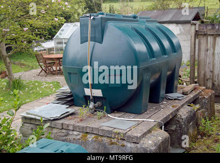 A large green plastic oil tank in a rural Cornish garden Stock Photo