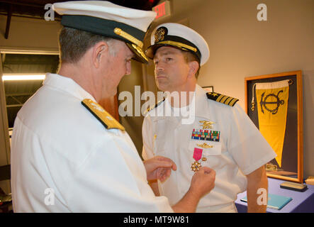 Virginia Beach, Va. (April 19, 2017) Rear Adm. Brian Brakke, commander, Navy Expeditionary Combat Command, awards Capt. Joseph Rehak the Legion of Merit during a change of command of Expeditionary Combat Readiness Center (ECRC). Capt. Matthew Jackson relieved Capt. Joseph Rehak at a ceremony on Joint Expeditionary Base Little Creek-Ft. Story. ECRC provides processing, equipping, training, certification and proactive family support to ADSW Sailors, Individual Augmnetees and provisional units throughout all deployment phases in support of COCOM requirements, contingency operations, or national c Stock Photo