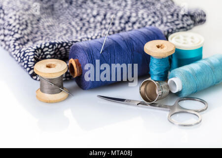 Sewing accessories and cloth on white background Stock Photo