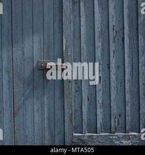 Peeling Paint weathered Door Grey Blue in colour Stock Photo